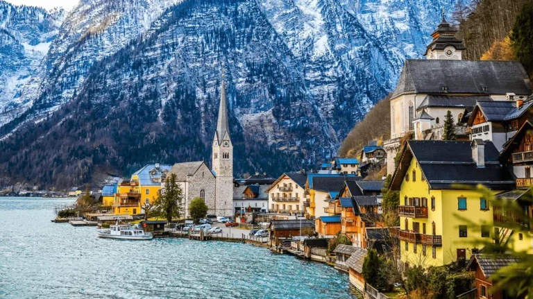 Làng Hallstatt bên hồ, với nhà thờ và núi phủ tuyết tại Áo